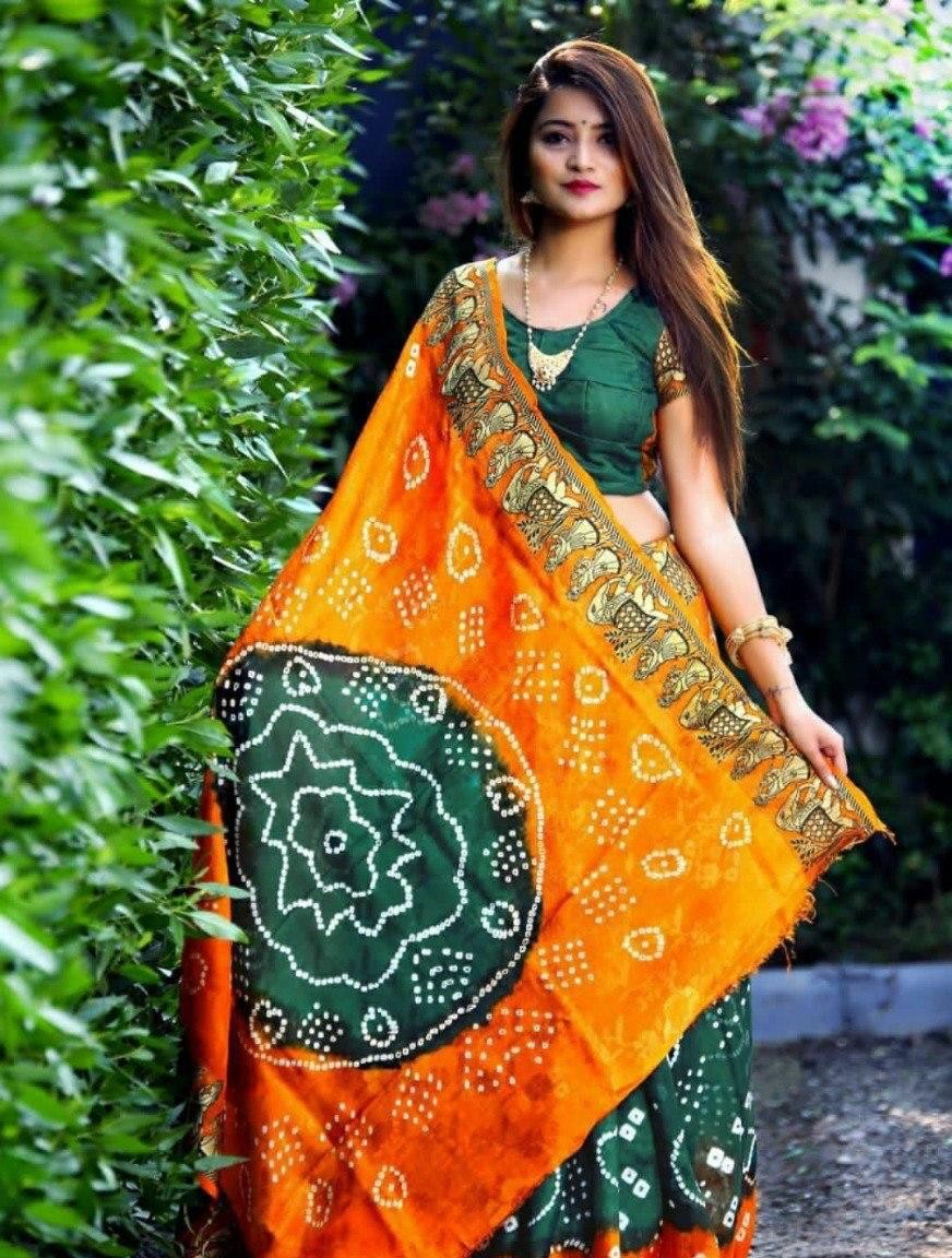 Orange and green hand bandhej bandhani saree with large bandhani pallu motif